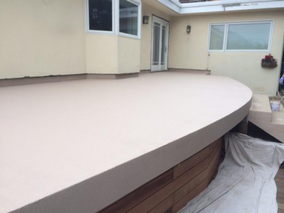 An elevated residential deck built in the backyard.